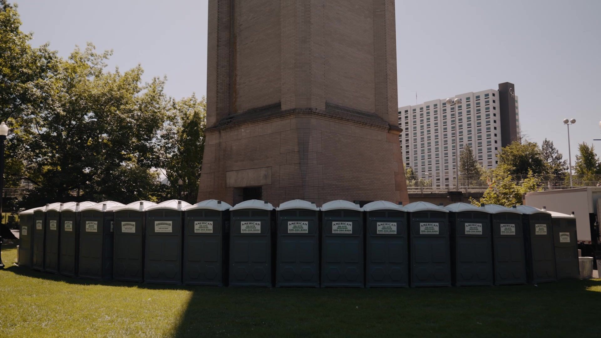 A long row of American On-Site restrooms at Hoopfest in Riverfront Park, Spokane